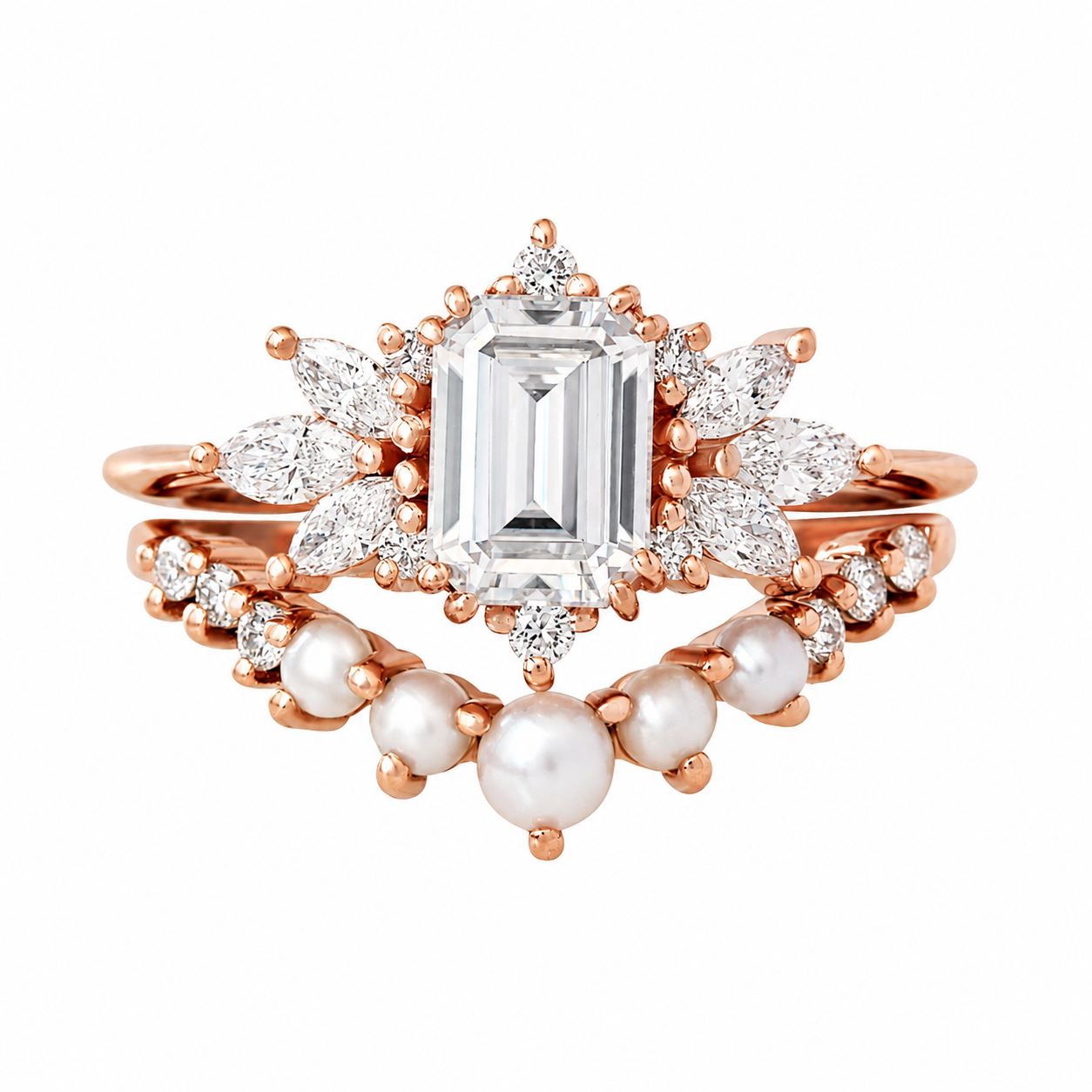 A rose gold ring set featuring a large emerald-cut clear center stone, surrounded by marquise and round clear stones, with a second matching ring layered behind it adorned with white pearls and small clear stones, all on a plain white background.