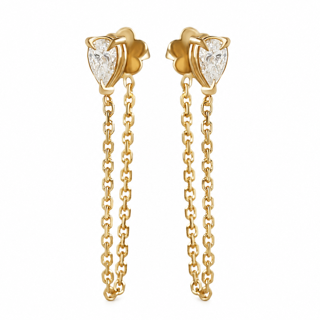 A pair of gold dangle earrings with heart-shaped stud tops set with clear stones and hanging chain drops, shown on a plain white background.
