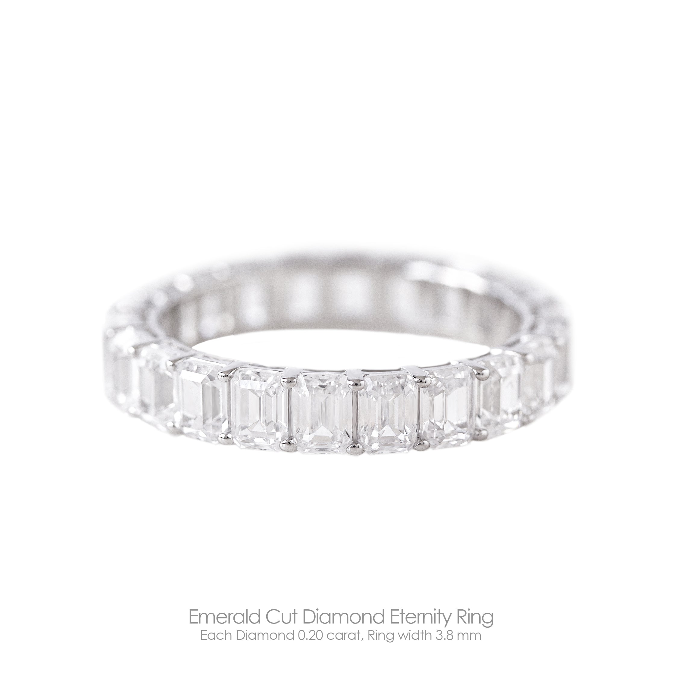 An emerald cut diamond eternity ring with a 3.8mm band width, each diamond is 0.