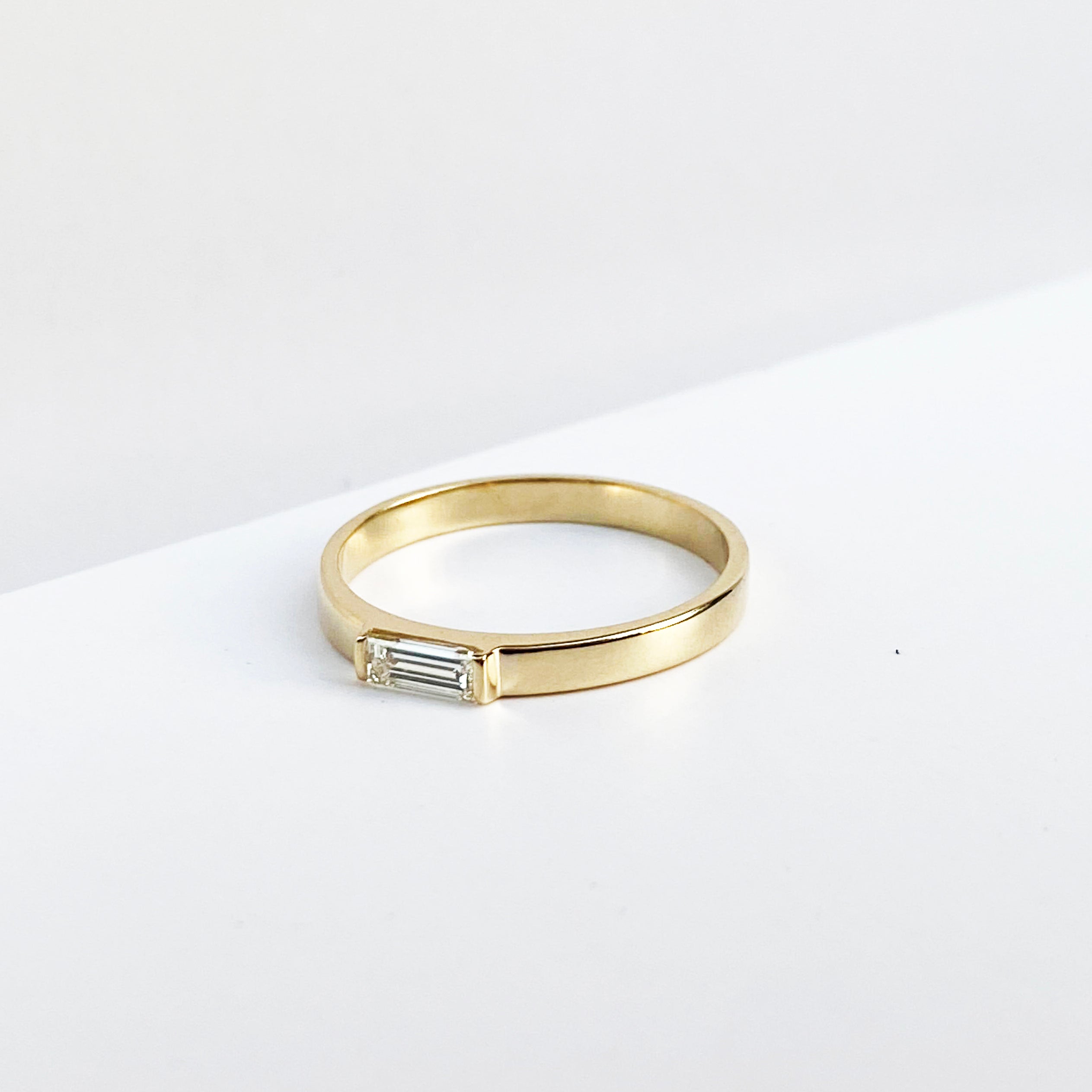 baguette center stone diamond ring, 14K yellow gold
