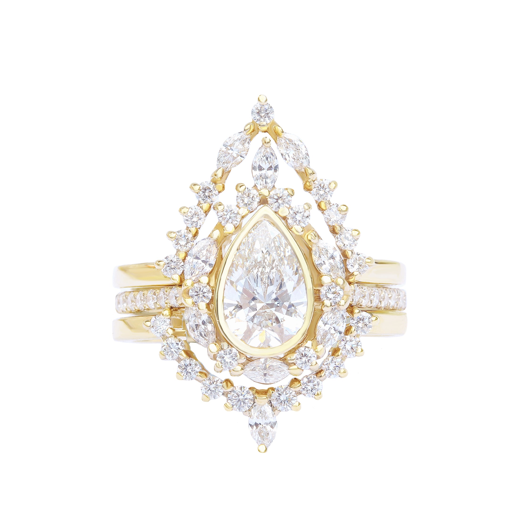 A unique engagement three-ring set featuring a pear diamond center stone, surrounded by smaller accent stones, set in a yellow gold band.