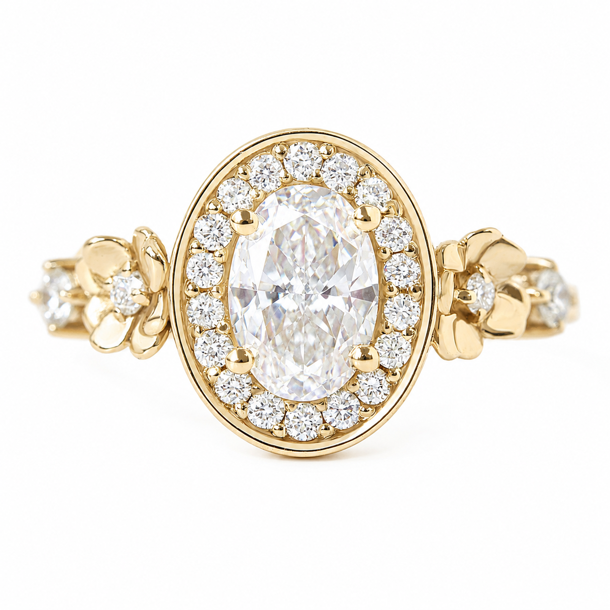 0.70ct oval diamond engagement ring. A yellow gold halo ring featuring a large oval-cut center stone surrounded by a double row of small round diamonds, with floral details on the band, set against a plain white background.