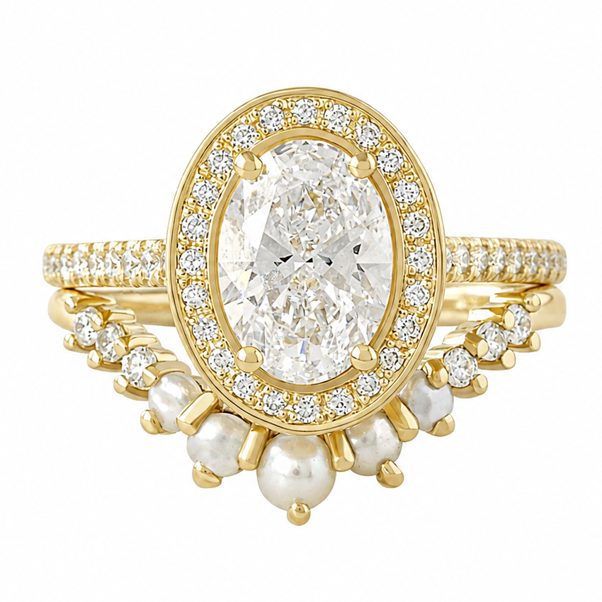 A yellow gold ring featuring a large 1.5ct oval cut diamond surrounded by a halo of small clear stones, with pearl and pavé-set details on the band, shown on a plain white background.