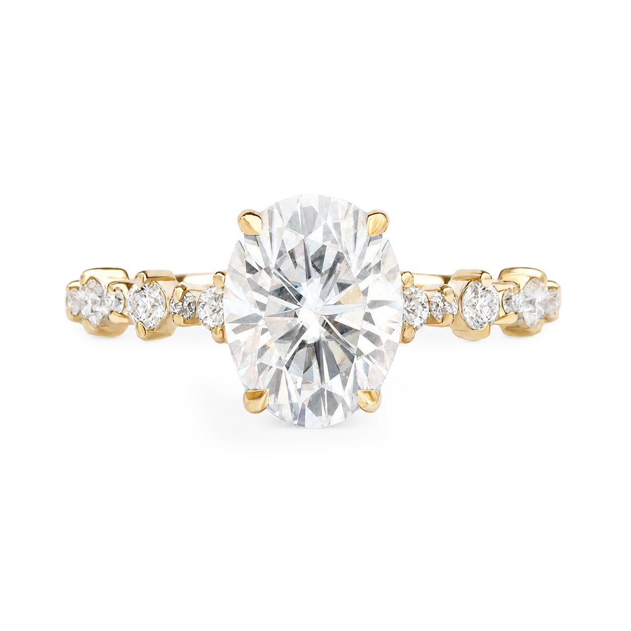 2CT oval-cut diamond solitaire ring set in yellow gold, flanked by smaller round diamonds on the shoulders, shown against a plain white background.