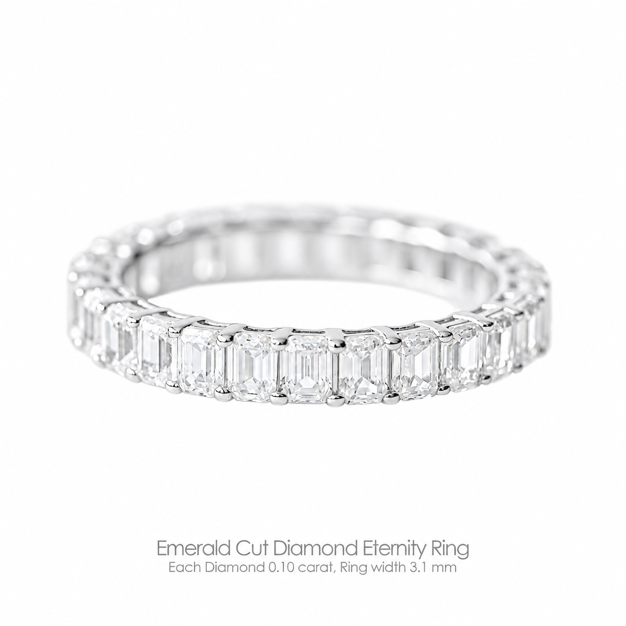 An emerald cut diamond eternity ring with a 3.1mm band width, each diamond is 0.10 carat, set in a white gold band.
