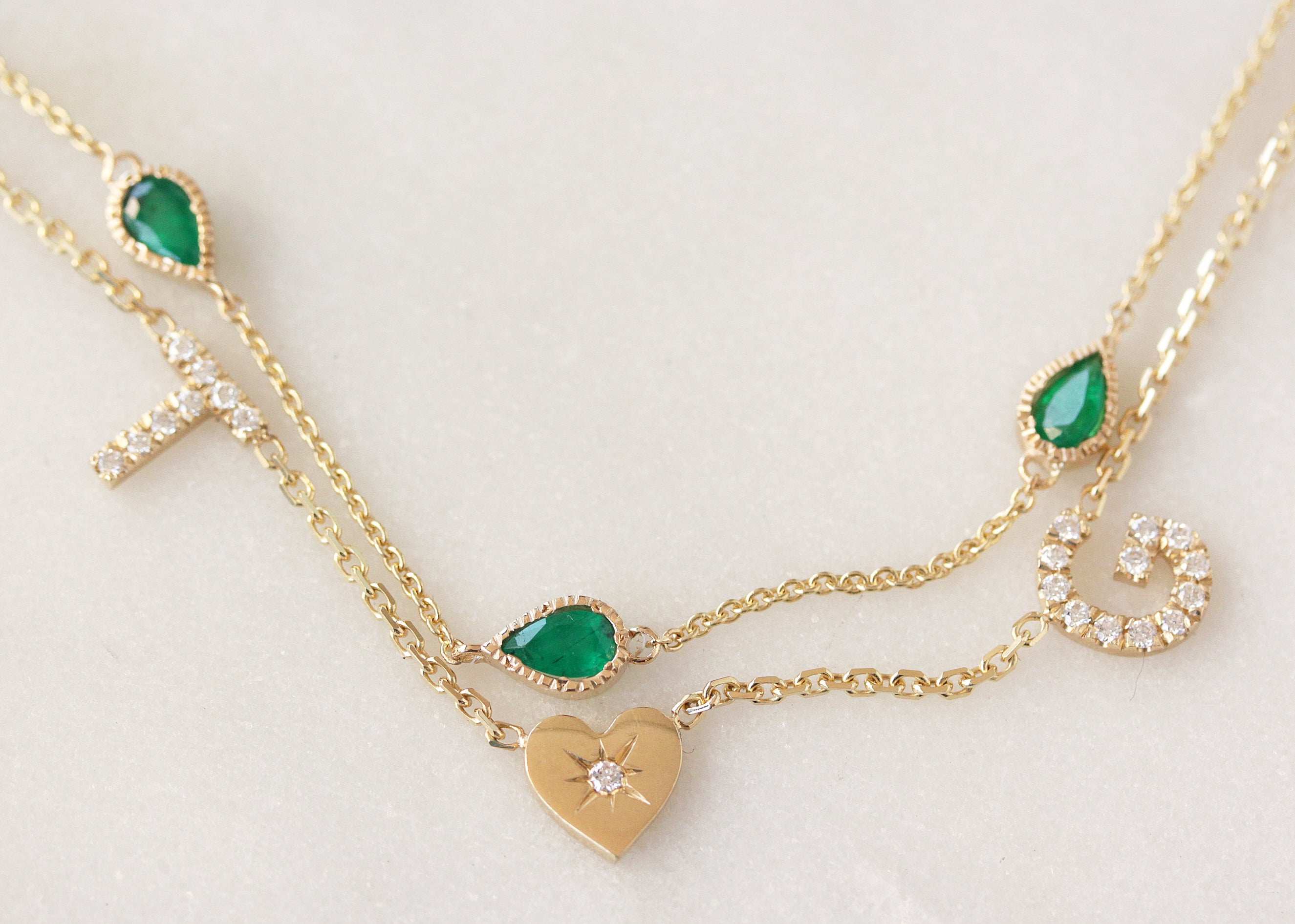 two diamond initials and a hearts yellow gold diamond personalized name necklace