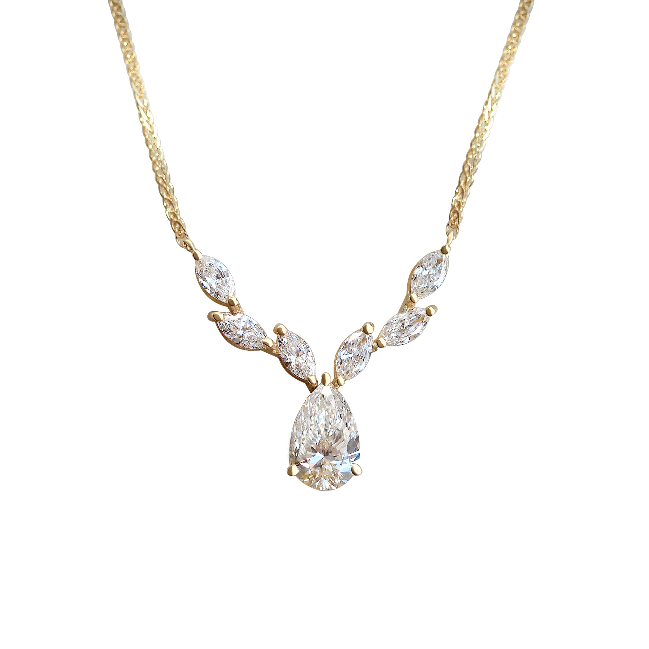 A white gold strand necklace featuring a central pear-shaped diamond with marquise-cut diamonds arranged in a floral pattern on the chain.