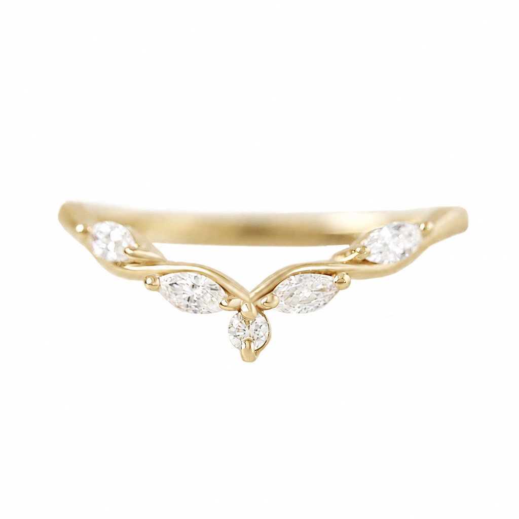 A delicate gold ring featuring a curved vine design with marquise-cut clear gemstones, set against a plain white background.