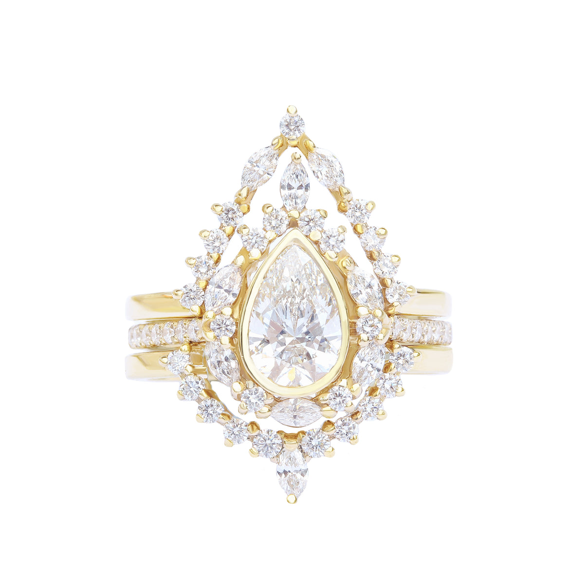 A unique engagement three-ring set featuring a pear diamond center stone, surrounded by smaller accent stones, set in a yellow gold band.
